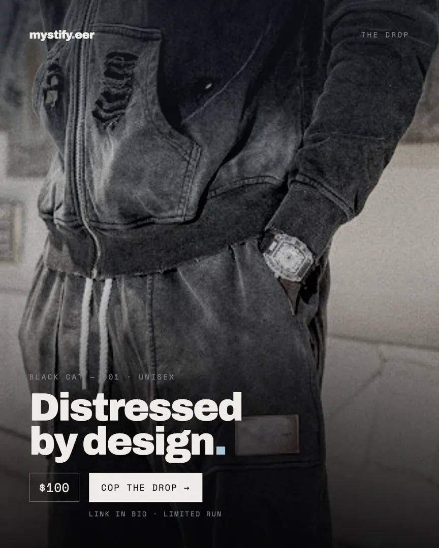 Close crop of the Black Cat 001 distressed hoodie and trousers with a watch at the cuff, headlined Distressed by design